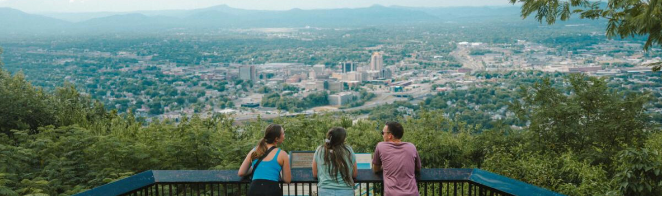 A group of people looking out over the valley by Mill Mountain Star